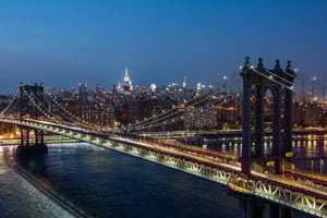 View of the Manhattan Bridge at night from Pier 36 in New York City 